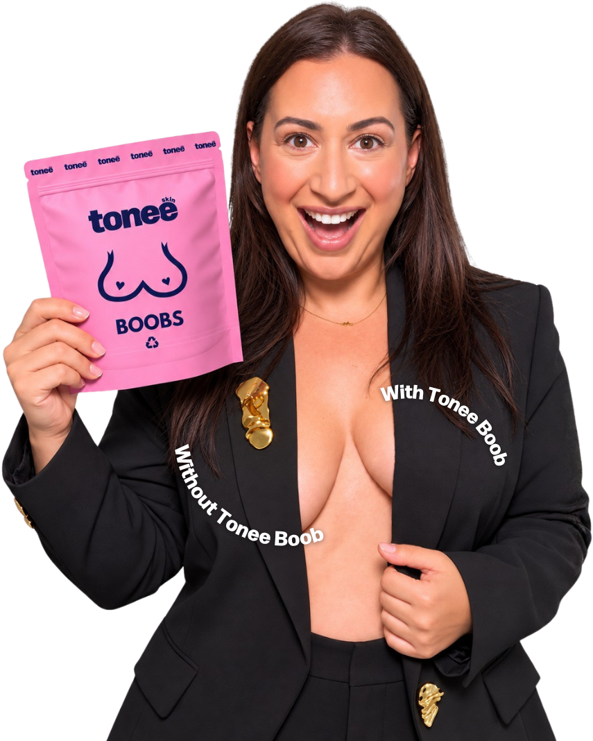 A woman in an open blazer holding a Tonee Boobs pack, one side labelled with Tonee Boob and the other without