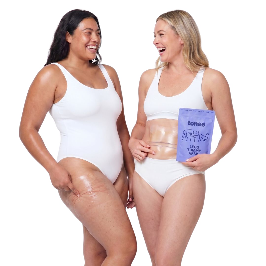 Two women laughing together, one holding a Tonee Legs, Tummy and Arms pack